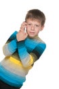 Thoughtful boy with a cell phone Royalty Free Stock Photo