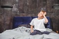 Thoughtful boy sitting on bed Royalty Free Stock Photo