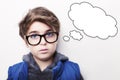 Thoughtful young boy wearing glasses with an empty thought bubble Royalty Free Stock Photo