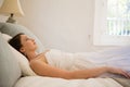 Thoughtful bride looking up while relaxing on bed Royalty Free Stock Photo