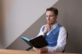 Thoughtful business man with beard in shirt and vest with notepad in his hand Royalty Free Stock Photo