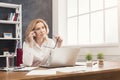 Thoughtful business woman at work talking on phone Royalty Free Stock Photo