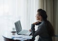 Thoughtful business woman working at hotel room