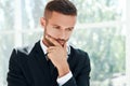 Thoughtful businessman portrait in modern creative office