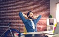 Thoughtful businessman relaxing in creative office Royalty Free Stock Photo