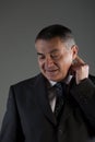 Thoughtful businessman scratching his ear Royalty Free Stock Photo