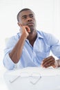 Thoughtful businessman sitting at his desk Royalty Free Stock Photo