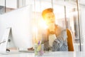 Thoughtful businessman sitting while using computer in office Royalty Free Stock Photo