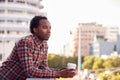 Thoughtful Businessman Standing Outside Office Building With City Skyline In Background Royalty Free Stock Photo