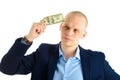 Thoughtful businessman in suit on white background holding cash. Thinking about making money. Royalty Free Stock Photo