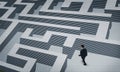 Thoughtful businessman trying to find way out of maze Royalty Free Stock Photo