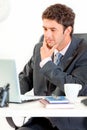 Thoughtful businessman working on laptop in office Royalty Free Stock Photo