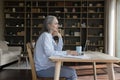 Thoughtful businesswoman look into distance sit at desk with laptop