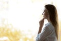 Thoughtful businesswoman looking through office window thinking of future Royalty Free Stock Photo