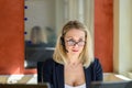 Thoughtful businesswoman peering over the top of her glasses Royalty Free Stock Photo