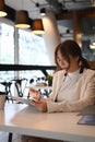 Thoughtful businesswoman reading news on digital tablet at modern workplace. Royalty Free Stock Photo