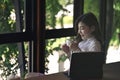 Thoughtful business woman sitting in office and drinking hot coffee. Royalty Free Stock Photo