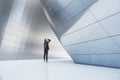 Thoughtful businesswoman standing in abstract  building open space interior Royalty Free Stock Photo