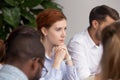 Thoughtful businesswoman thinking of business challenges opportunities at group meeting