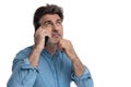 Thoughtful casual man talking on his phone, looking up Royalty Free Stock Photo