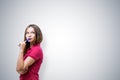 Thoughtful casual young woman with marker, mock up Royalty Free Stock Photo