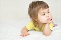 Thoughtful child , thinking Little girl lying on bed looking awa Royalty Free Stock Photo