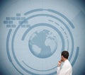 Thoughtful classy businessman looking at holographic earth Royalty Free Stock Photo