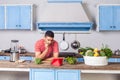 Thoughtful confused man watching food blog using tablet in modern kitchen, looking for dish recipe