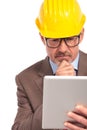Thoughtful construction engineer reading on his tablet pad Royalty Free Stock Photo