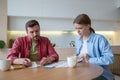 Thoughtful couple planning family budget, analysing, counting expenses on smartphone calculator Royalty Free Stock Photo