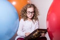 Thoughtful curly teen girl in glasses with wooden abacus on the Royalty Free Stock Photo
