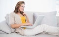 Thoughtful cute woman using laptop Royalty Free Stock Photo