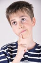 Thoughtful cute young boy looking up Royalty Free Stock Photo