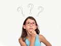 Thoughtful young girl with three question marks