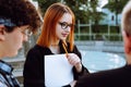 Thoughtful and cute young student looking aside, thinking about education and university among friends Royalty Free Stock Photo