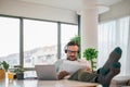 Thoughtful dedicated focused pensive businessman entrepreneur with feet on the table working with documents and laptop computer Royalty Free Stock Photo