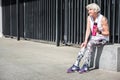 Thoughtful elderly woman resting while exercising outdoor Royalty Free Stock Photo