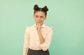 Thoughtful elementary school child think looking away blue background, serious