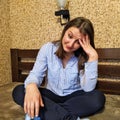 Thoughtful european woman sit on bed at home