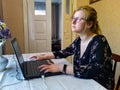 Thoughtful european woman work on laptop at home