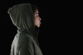 Thoughtful female athlete in hooded jacket