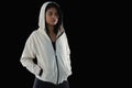 Thoughtful female athlete in hooded jacket