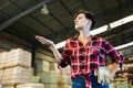 Thoughtful female storekeeper looking for tedious goods in building materials warehouse indoor