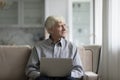 Thoughtful focused senior retired man holding laptop computer Royalty Free Stock Photo