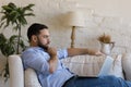 Thoughtful focused young millennial business man using laptop working Royalty Free Stock Photo