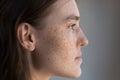 Thoughtful freckled teenage girl facial close up Royalty Free Stock Photo