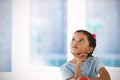 Composite image of thoughtful girl against white background Royalty Free Stock Photo