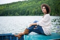 Thoughtful girl sits in a boat on a lake Royalty Free Stock Photo