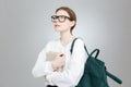 Thoughtful girl student with backpack holding book and thinking Royalty Free Stock Photo