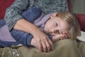 Thoughtful granddaughter of 8 years old rest on grandmother`s lap in living room Royalty Free Stock Photo